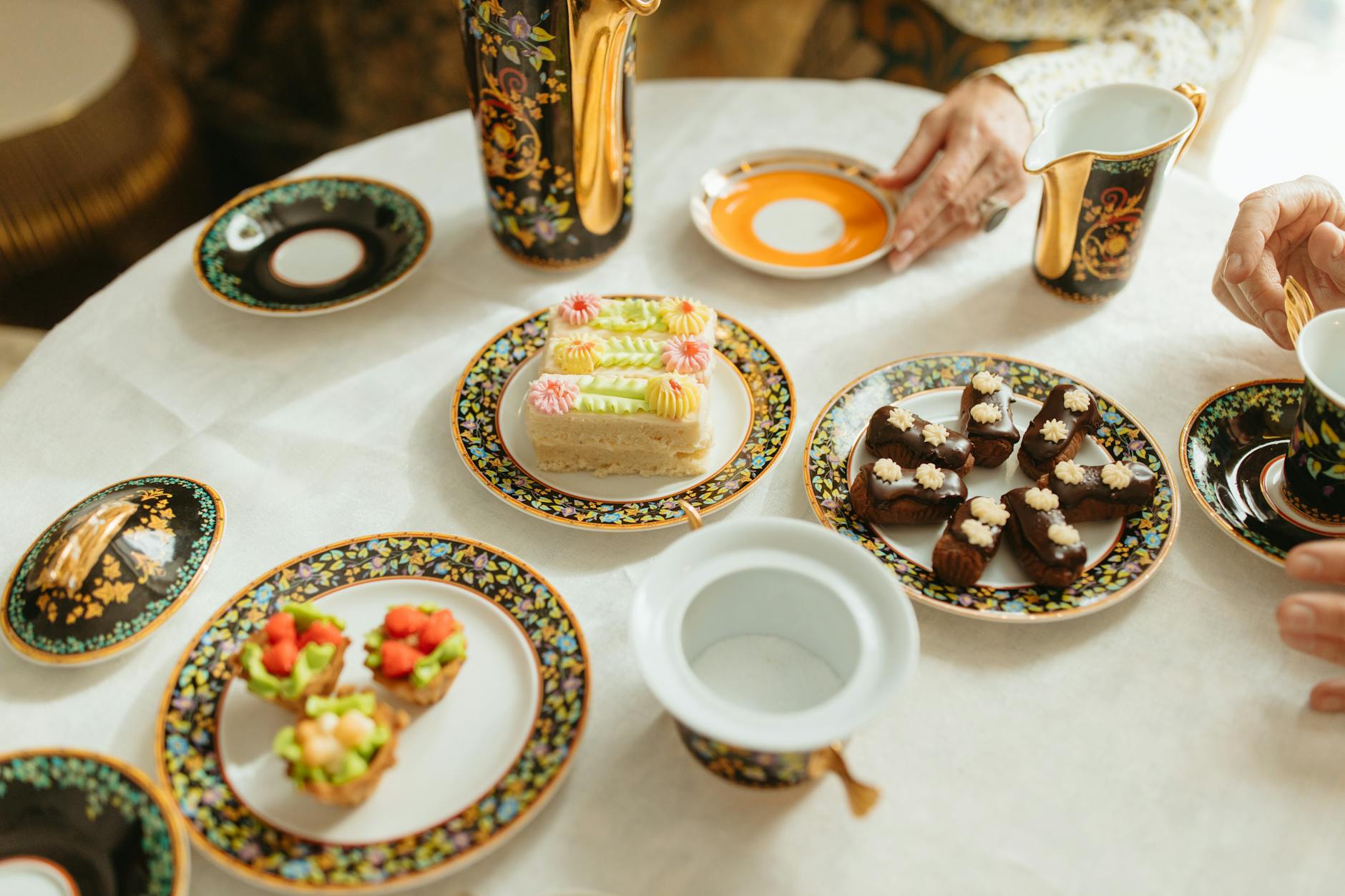 Decorated dessert display with cakes and floral accents from Lily’s Chocolates & Café, perfect for tea parties!